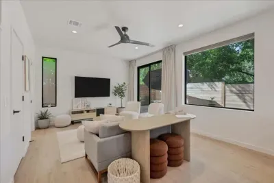 Living Room that has a half bathroom and opens to the patio.