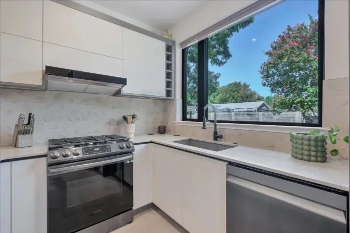 Oversized and casement windows over the kitchen sink and next to Gas stove, under counter microwave, dishwasher and large fridge and freezer make this space feel luxurious and modern. All spices, coffee, bottled water included.