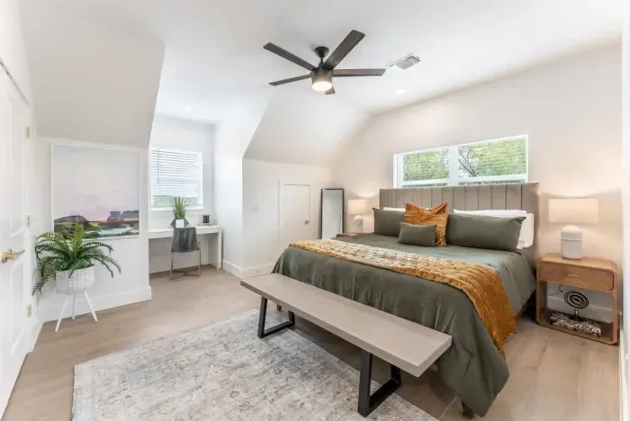 Beautifully designed bedroom featuring a cozy bed soft linens and warm natural light.