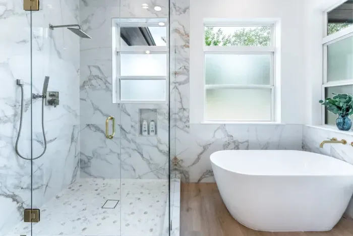 Elegant bathroom with a spa atmosphere including a freestanding tub and walk-in shower.