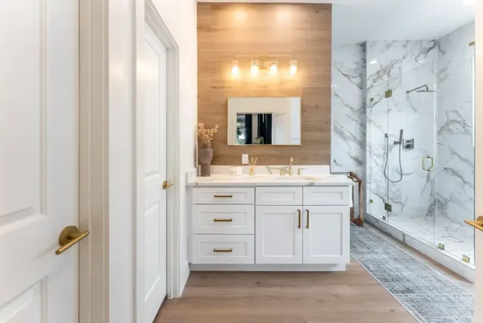 Bright and modern primary bathroom with dual sinks premium lighting and sleek finishes.