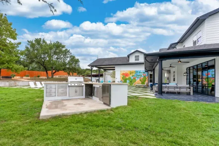 Expansive modern backyard built for entertaining with outdoor lounge space and open views.