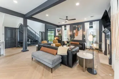 Living room equipped with a large TV and stylish decor.