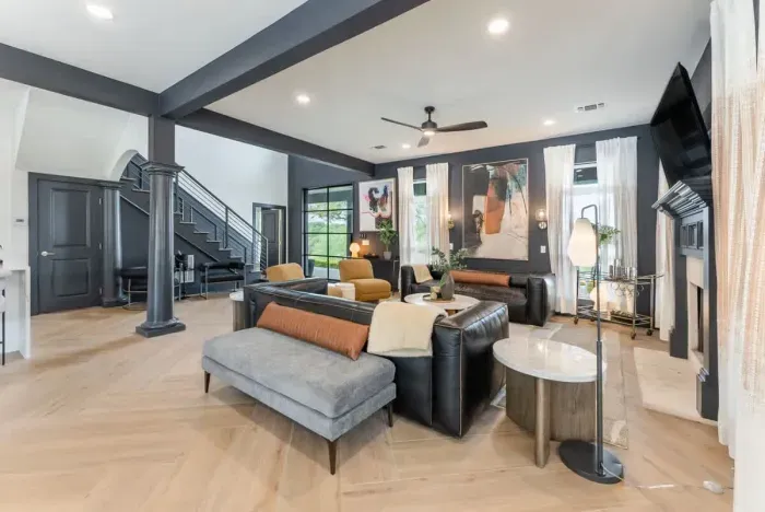 Living room equipped with a large TV and stylish decor.