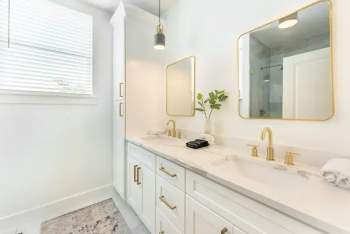 Refresh in a sparkling spa level bathroom with a fully tiled shower and elegant gold accents.