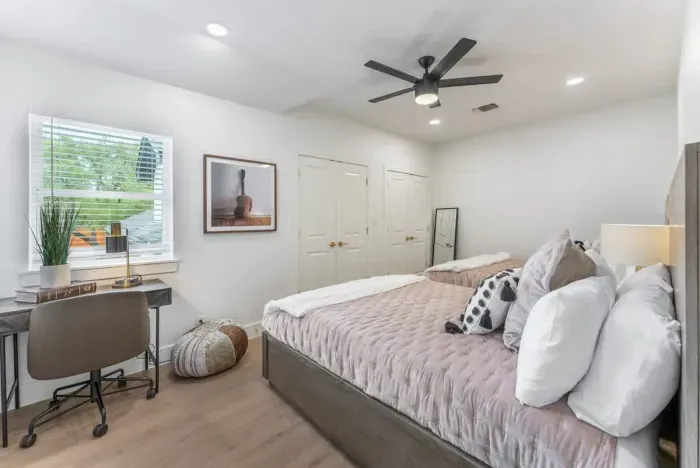 Retreat to a tranquil bedroom featuring a plush king bed and calming upscale décor.