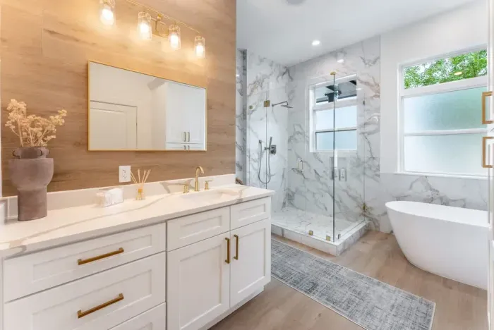 Elegant bathroom featuring a large vanity, soaking tub, and chic design.