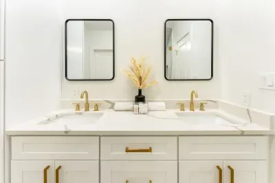 Indulge in a pristine spa inspired bathroom with dual vanities and exquisite finishes.