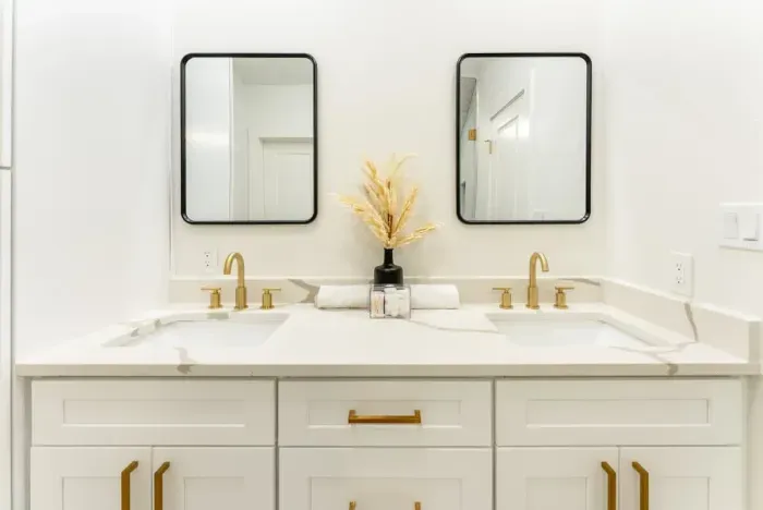 Indulge in a pristine spa inspired bathroom with dual vanities and exquisite finishes.