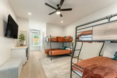 Relax in a spacious bedroom with a modern bunk layout and stylish designer touches.