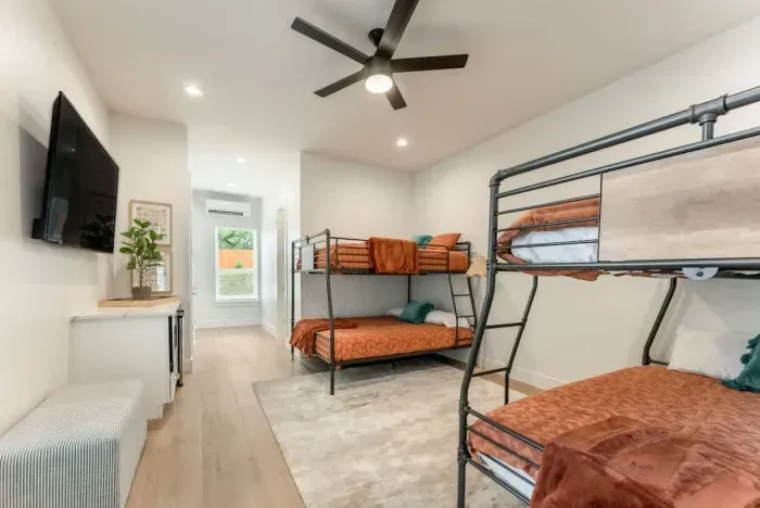 Relax in a spacious bedroom with a modern bunk layout and stylish designer touches.