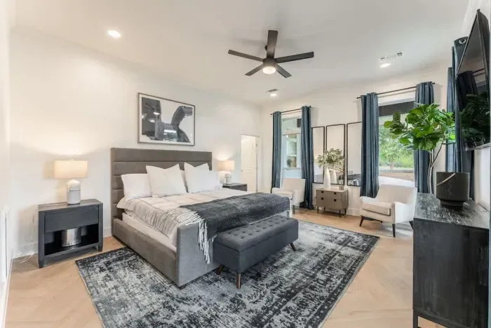 Spacious primary bedroom with a king size bed and serene ambiance.