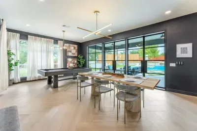 Versatile dining area with panoramic windows ideal for meals meetings or entertaining.