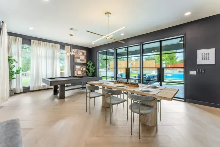 Versatile dining area with panoramic windows ideal for meals meetings or entertaining.