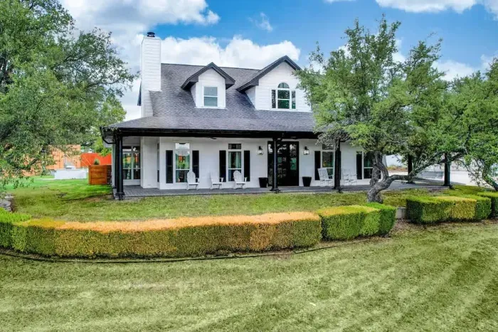 A welcoming grand entrance with lush landscaping and classic curb appeal.