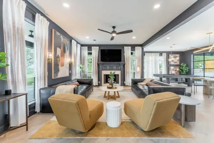 Modern living room with sleek furnishings and abundant natural light.