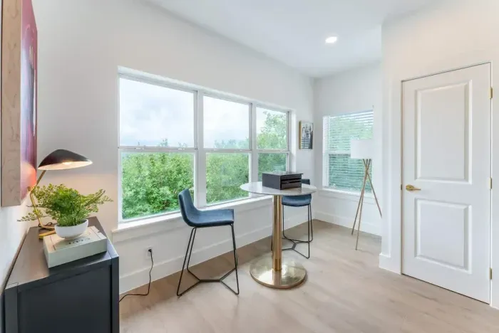 Boost productivity in a sunlit workspace designed with sophistication and comfort.