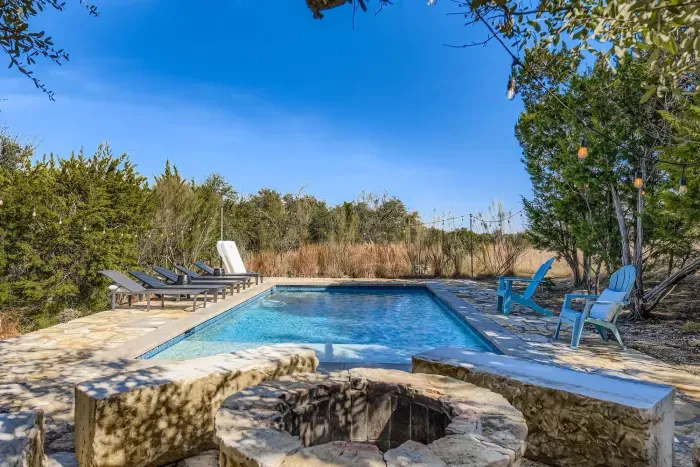 Resort style pool with lounge seating.