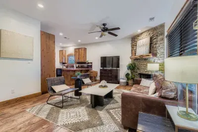 Bright living room with stone fireplace.