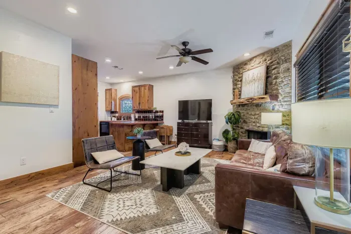 Bright living room with stone fireplace.