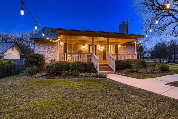 Charming exterior with a welcoming front porch and beautifully landscaped yard.