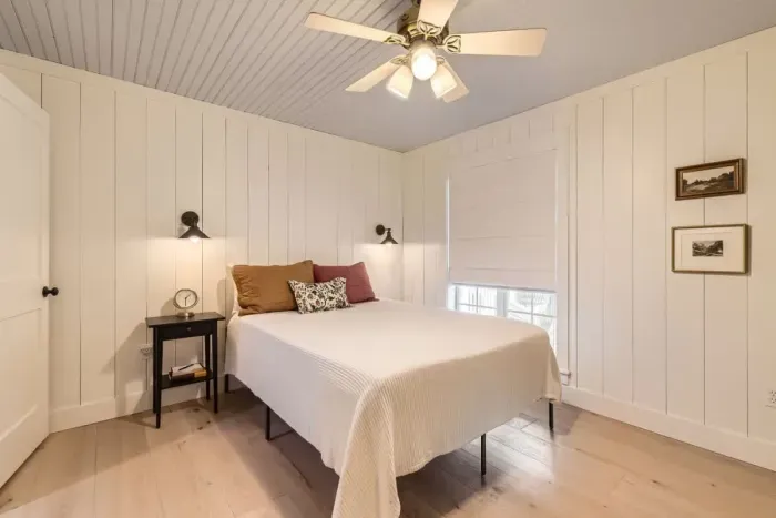 Peaceful bedroom with a plush queen-sized bed and soft linens for a restful night’s sleep.