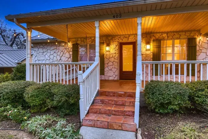 Charming exterior with a welcoming front porch and beautifully landscaped yard.