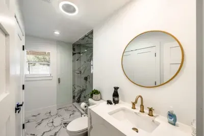 A spacious designer bathroom featuring polished finishes and serene luxury