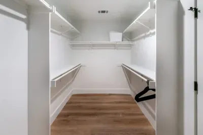 An impressive walk-in closet offering abundant storage and refined finishes.