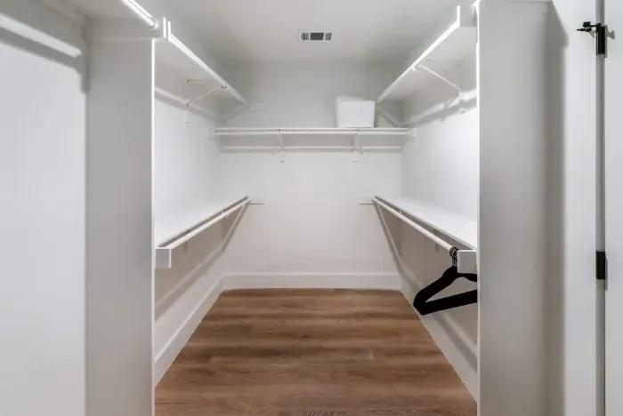 An impressive walk-in closet offering abundant storage and refined finishes.