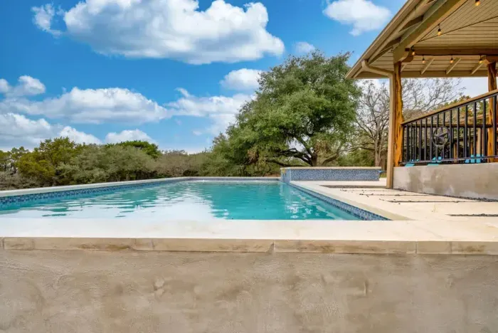 Make a splash in this sparkling backyard pool framed by wide-open skies.