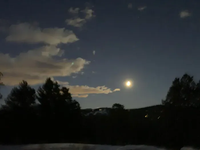 As the evening settles in, the stars are just about to come out, lighting up the sky with their twinkling glow. The quiet anticipation of the night sky creates a magical, peaceful atmosphere.