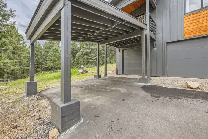 Spacious carport offering sheltered parking, protecting your vehicles from the elements. Its open design provides easy access while ensuring your car stays safe and secure, perfect for year-round convenience.