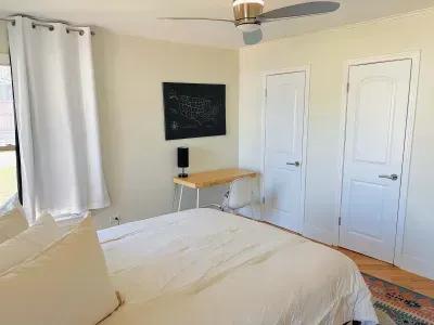 Bright, airy bedroom with a desk for slow mornings or focused hours