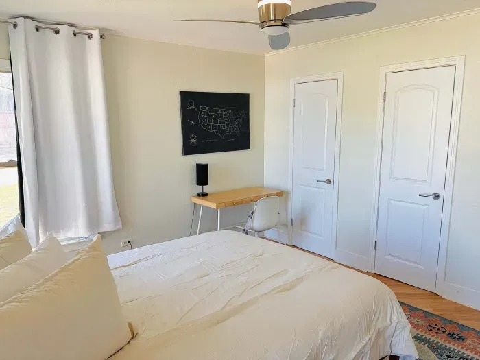 Bright, airy bedroom with a desk for slow mornings or focused hours