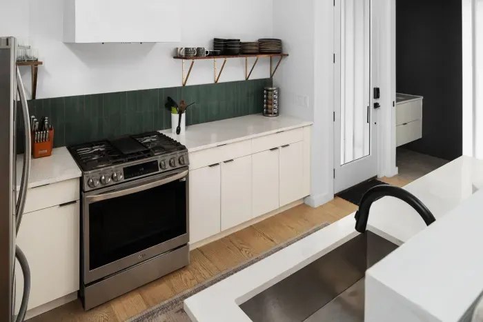 Bright and modern kitchen with stainless steel appliances, perfect for preparing a gourmet meal or quick snacks.