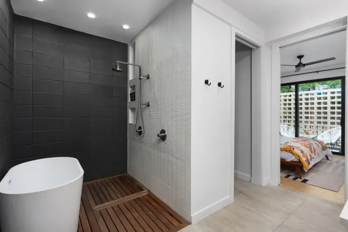 Elegant bathroom featuring a deep soaking tub and a luxurious rainfall shower.