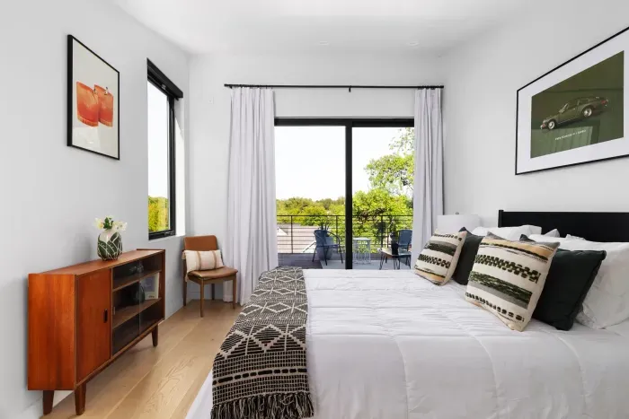A bright and airy bedroom with a queen bed and ample sunlight pouring in, creating a peaceful retreat to relax and recharge.