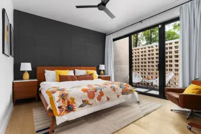 Spacious primary bedroom with a king-sized bed and an en-suite bathroom.