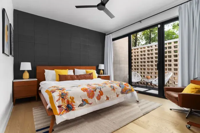 Spacious primary bedroom with a king-sized bed and an en-suite bathroom.