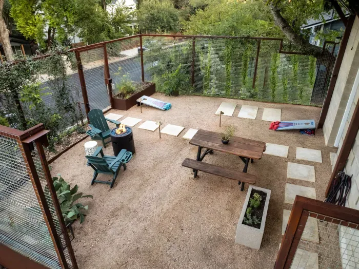 Spacious backyard with a covered patio area for dining, lounging, or entertaining.