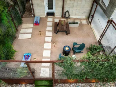 Spacious backyard with a covered patio area for dining, lounging, or entertaining.