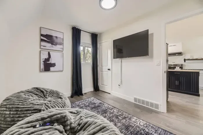 Relaxing lounge room off the kitchen, offering a cozy space to unwind or entertain. With comfortable seating and a casual atmosphere, it provides the perfect spot to relax while staying connected to the heart of the home. Ideal for family gatherings,