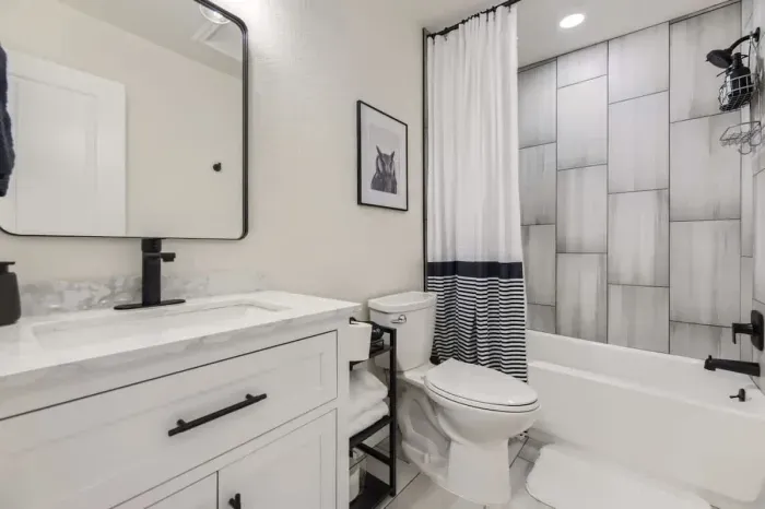 A refreshing, clean bathroom with charming decor and all the essentials.