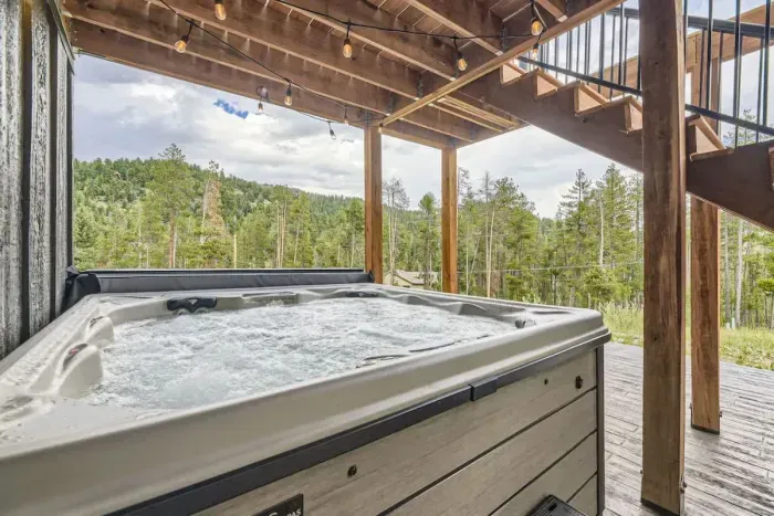 2. Relax in the hot tub on the patio, offering stunning views and convenient access to the primary bedroom or the deck off the kitchen. Ideal for unwinding after a long day, this private outdoor space combines luxury and comfort.