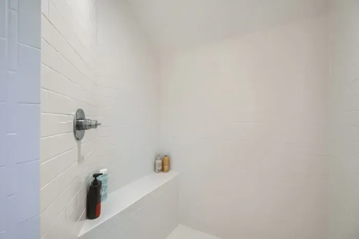 Cozy bathroom with a walk-in shower and chic, minimalist design.