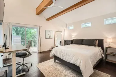 4. Spacious primary bedroom with a king-sized bed and an en-suite bathroom.