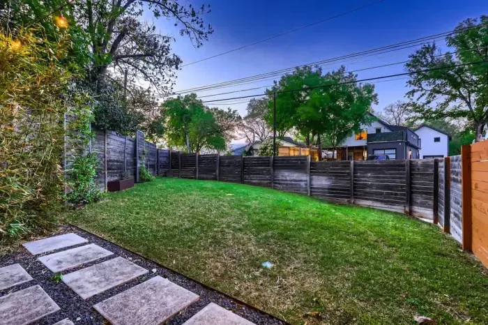 Private backyard with tall fences, providing a quiet and secure space for relaxation.