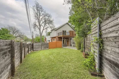 Beautifully landscaped backyard with a combination of greenery, flowers, and a peaceful atmosphere.