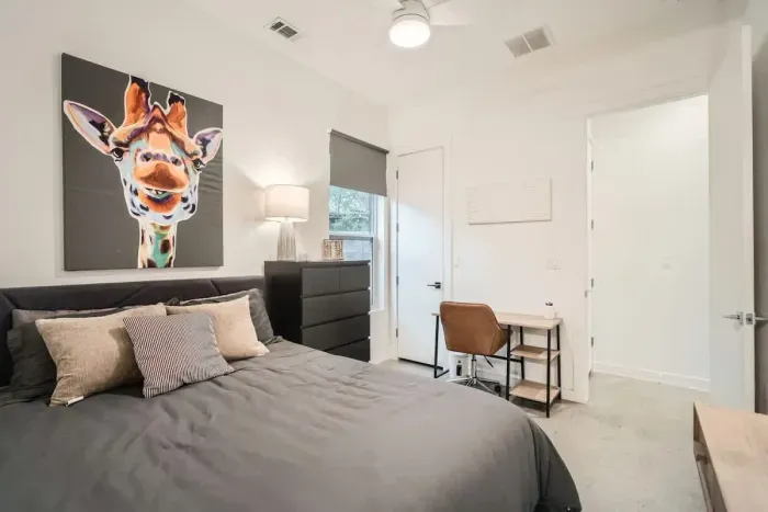 Functional and stylish bedroom with a desk for remote work or study.